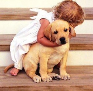 Little girl hugging puppy